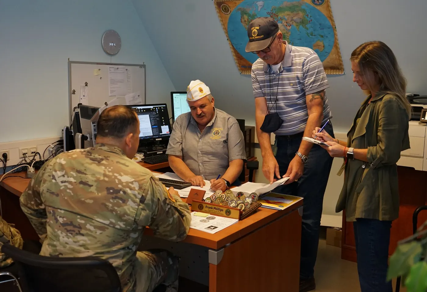 Veterans and a service officer helping a soldier with paperwork