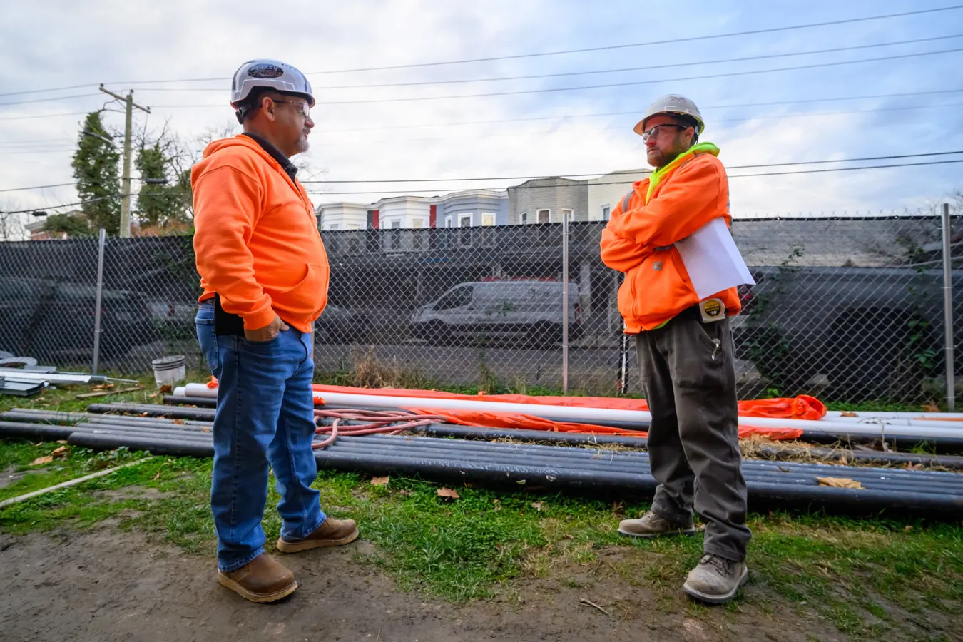 Experienced operator and next leader talking on a job site